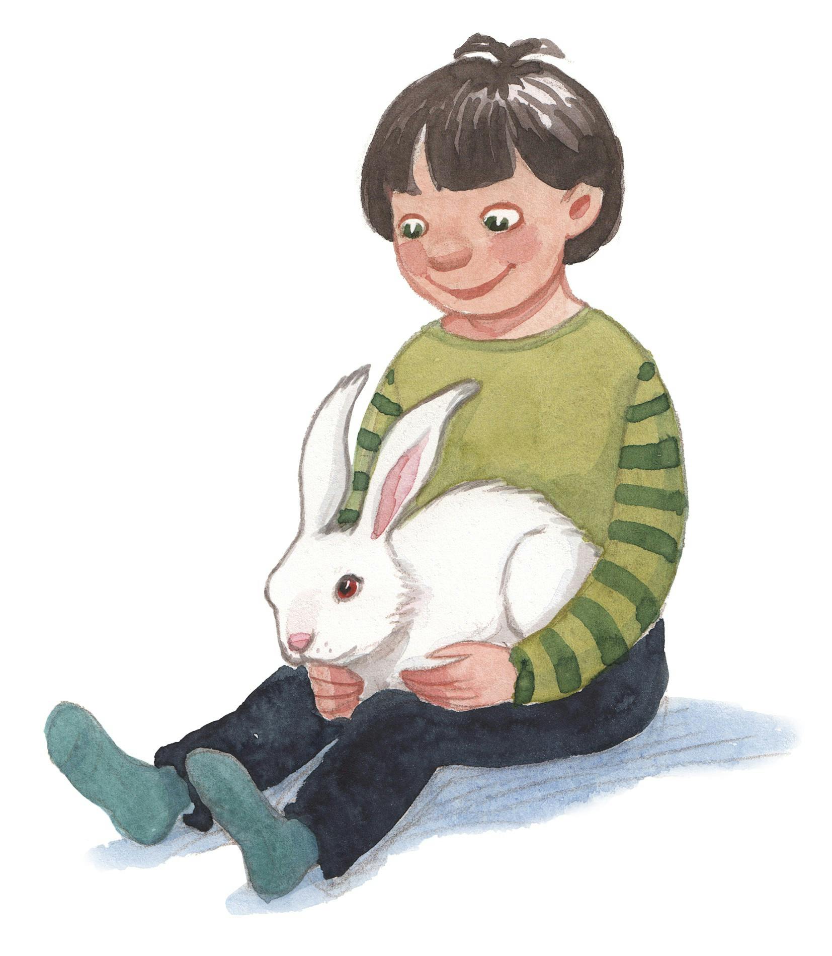 Et barn sidder med en kanin