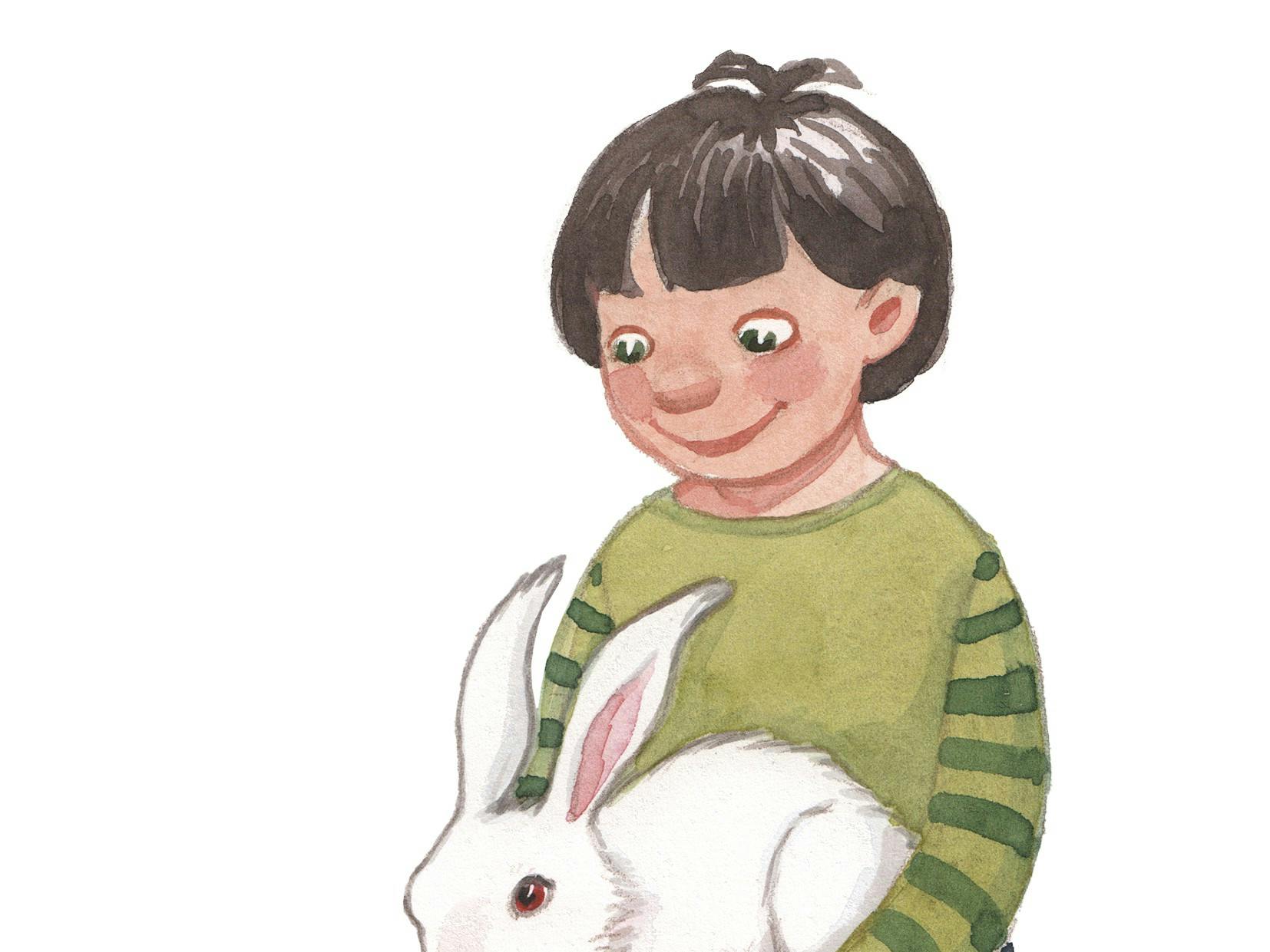 Et barn sidder med en kanin