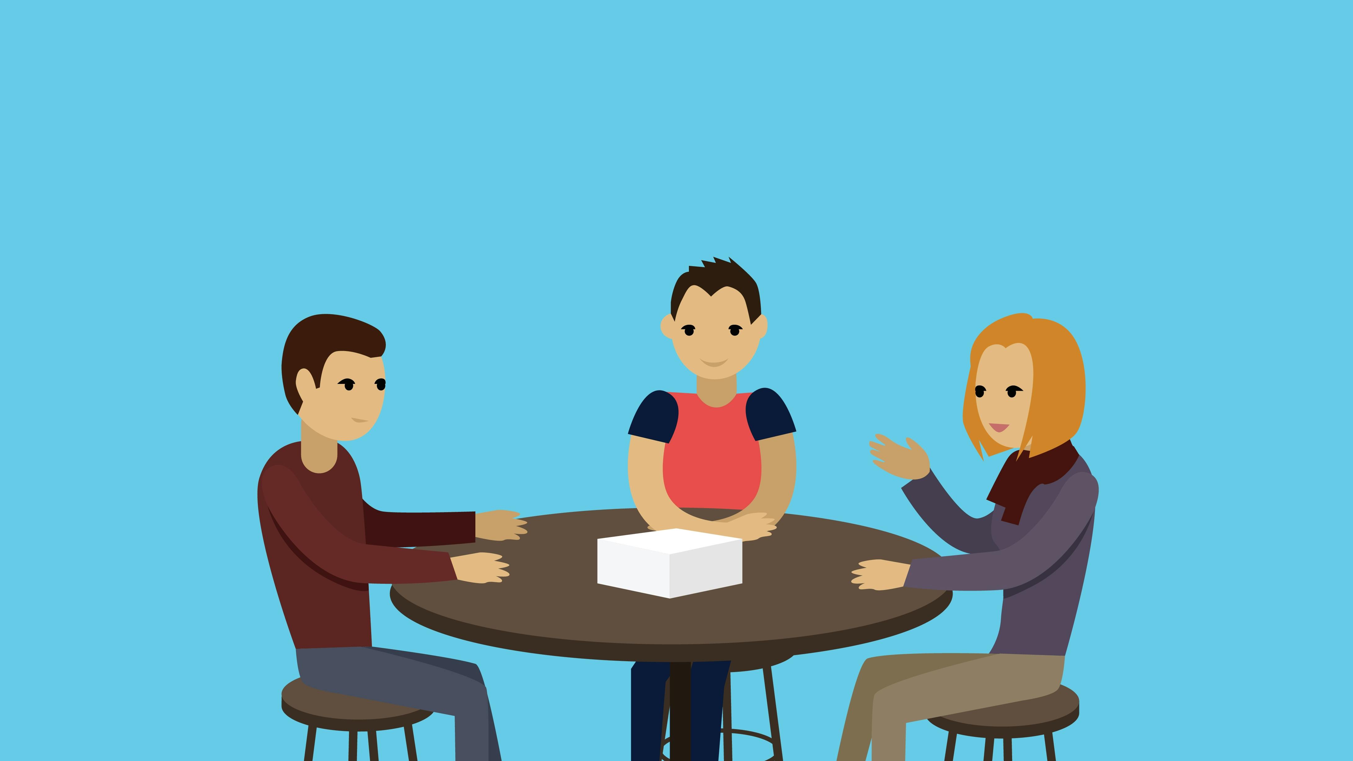 Tre personer sidder rund om et bord