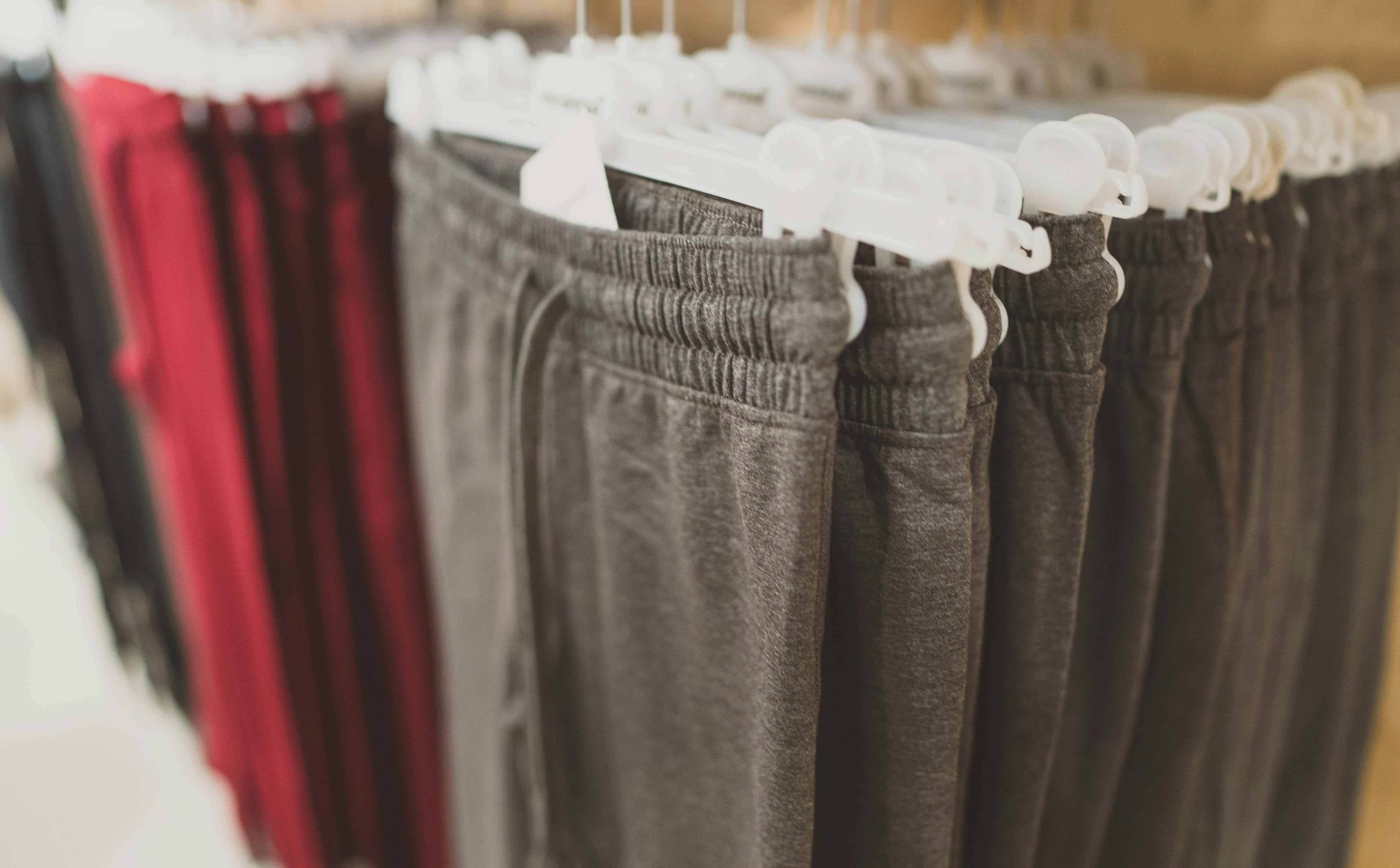 Rack with sweatpants in clothing store.