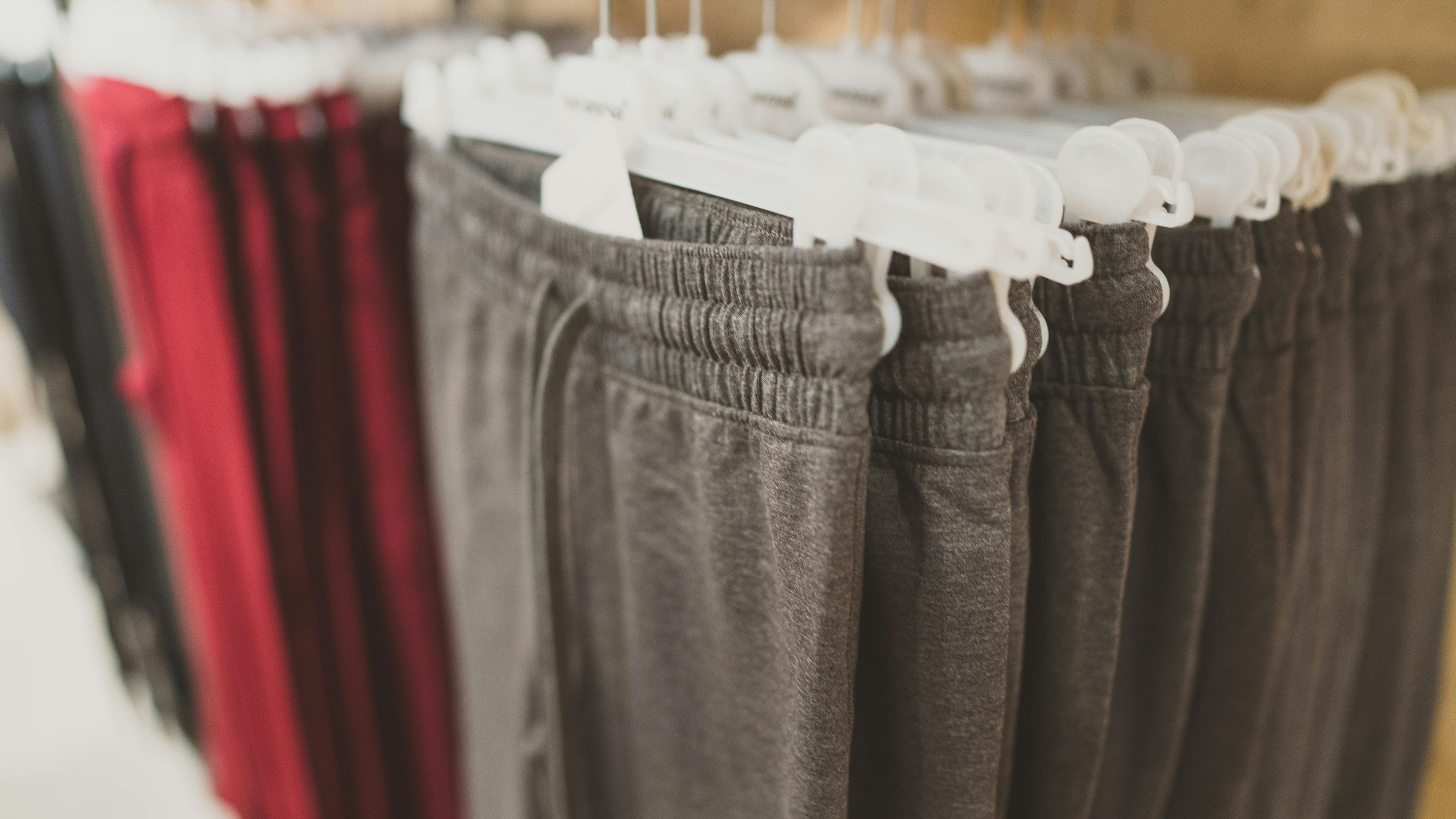 Rack with sweatpants in clothing store.