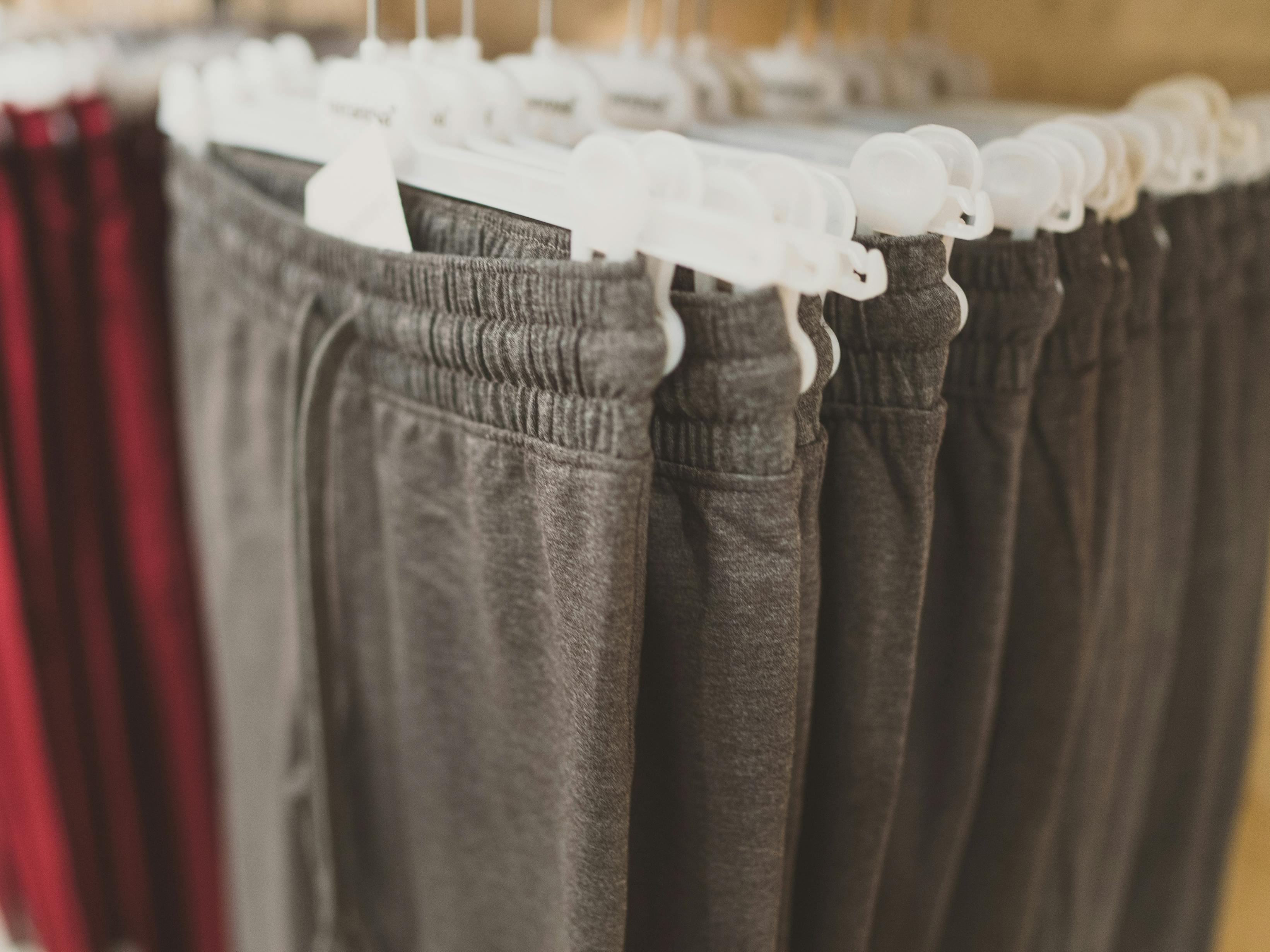 Rack with sweatpants in clothing store.