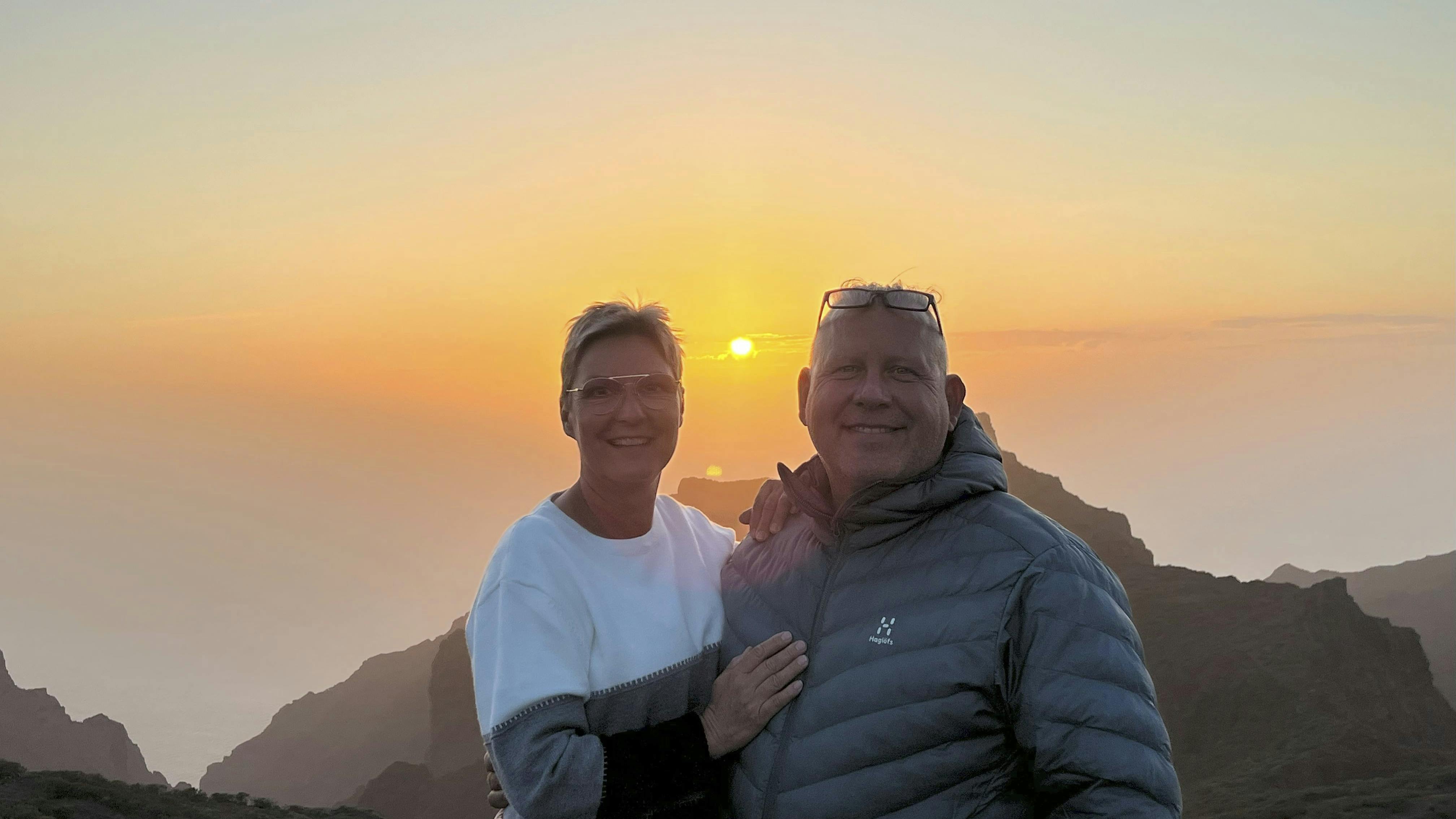 Sussi og Henrik, der står sammen ved en solnedgang.