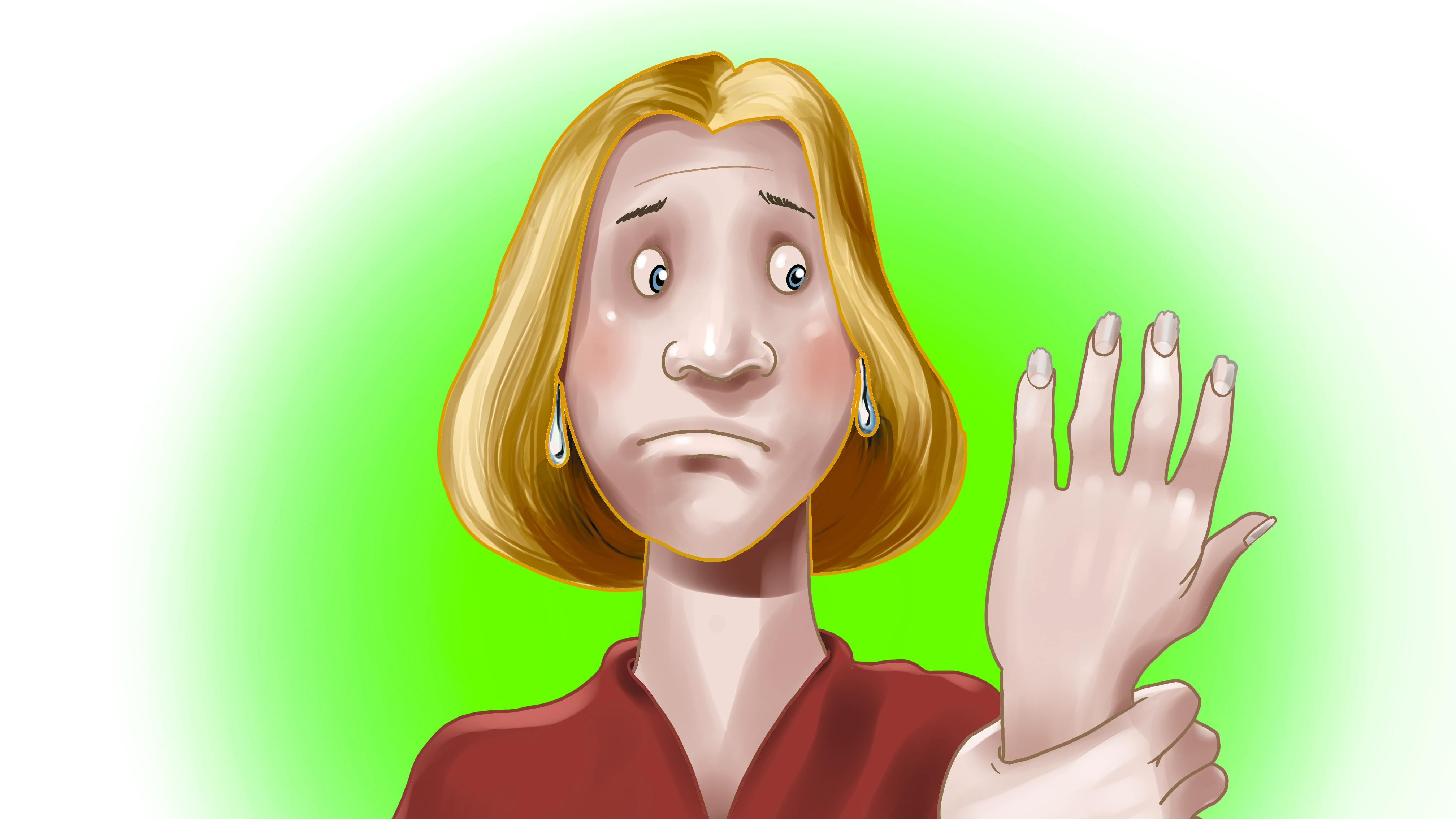 Kvinde tager sig til hånden med smerte