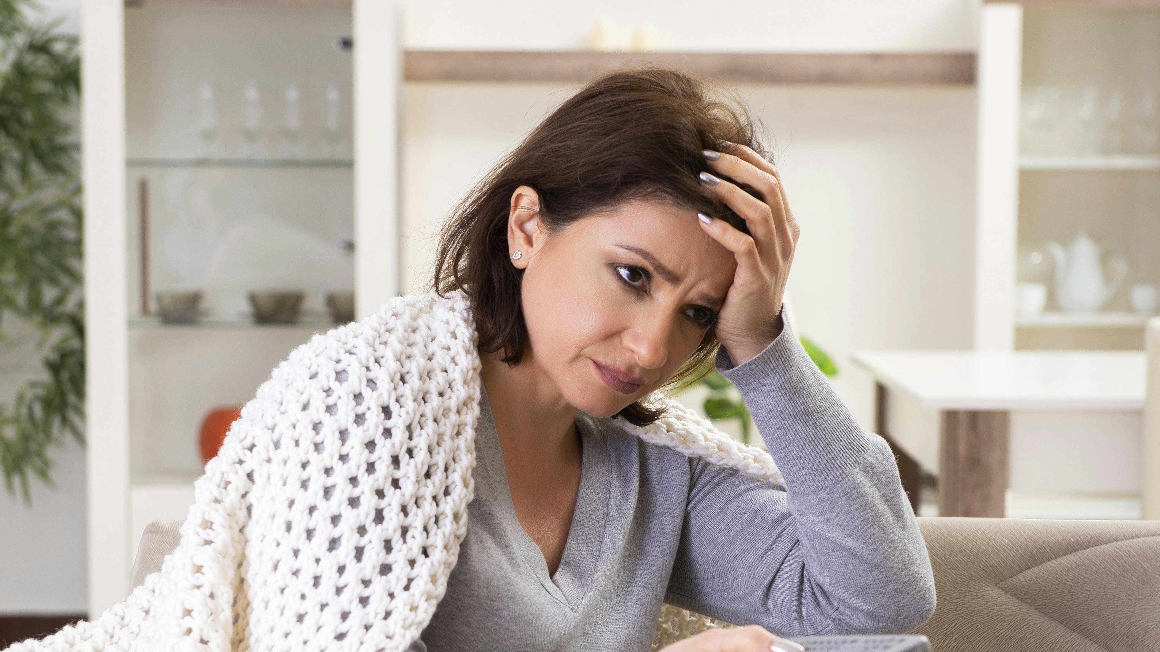The sick middle-aged woman suffering at home
