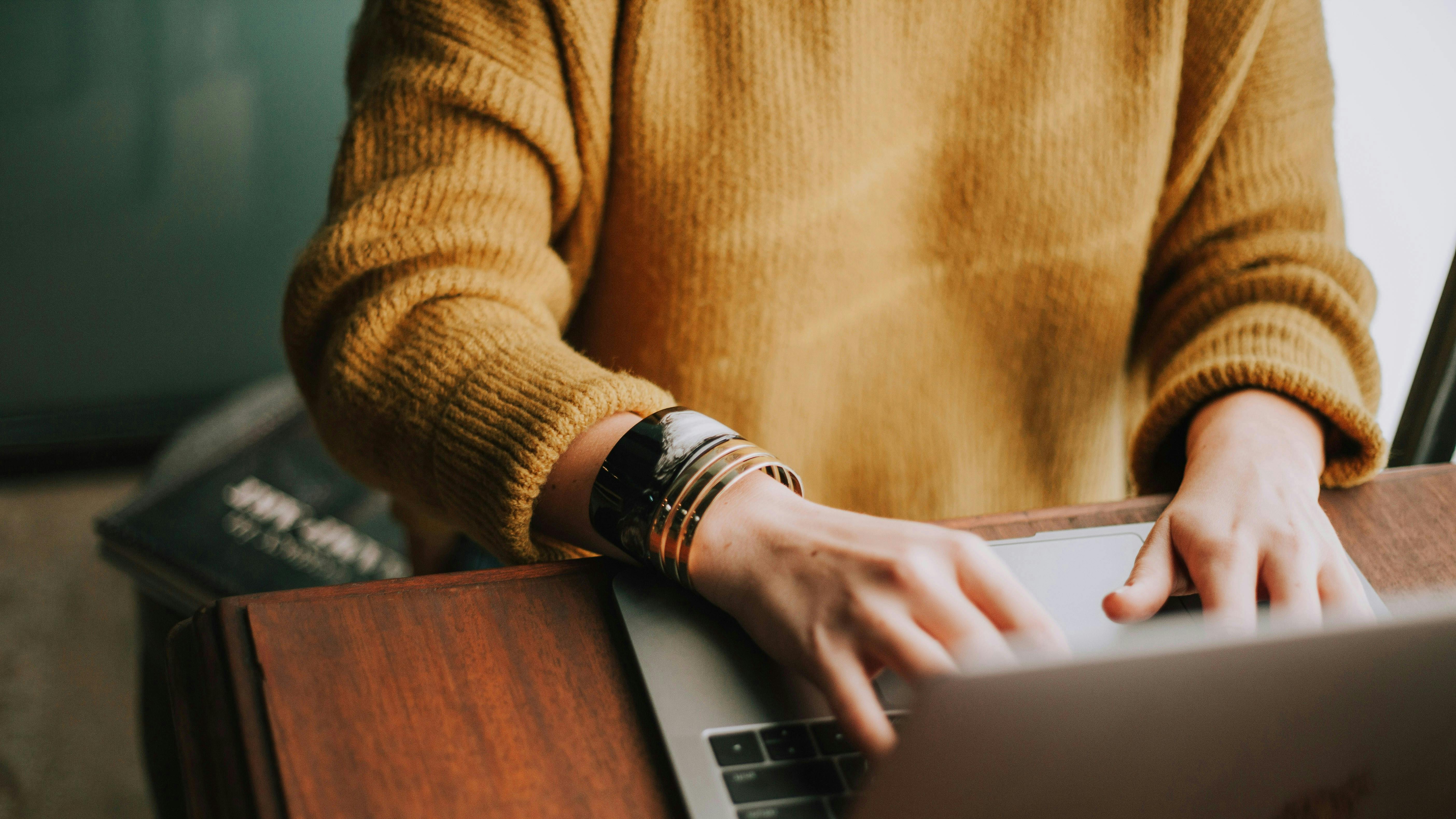 Woman typing on a computer.
