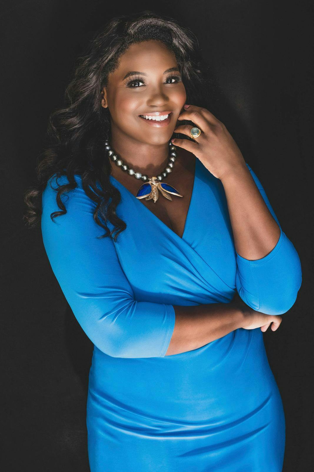 Sopranen Angel Blue iført blå kjole og perlekæde