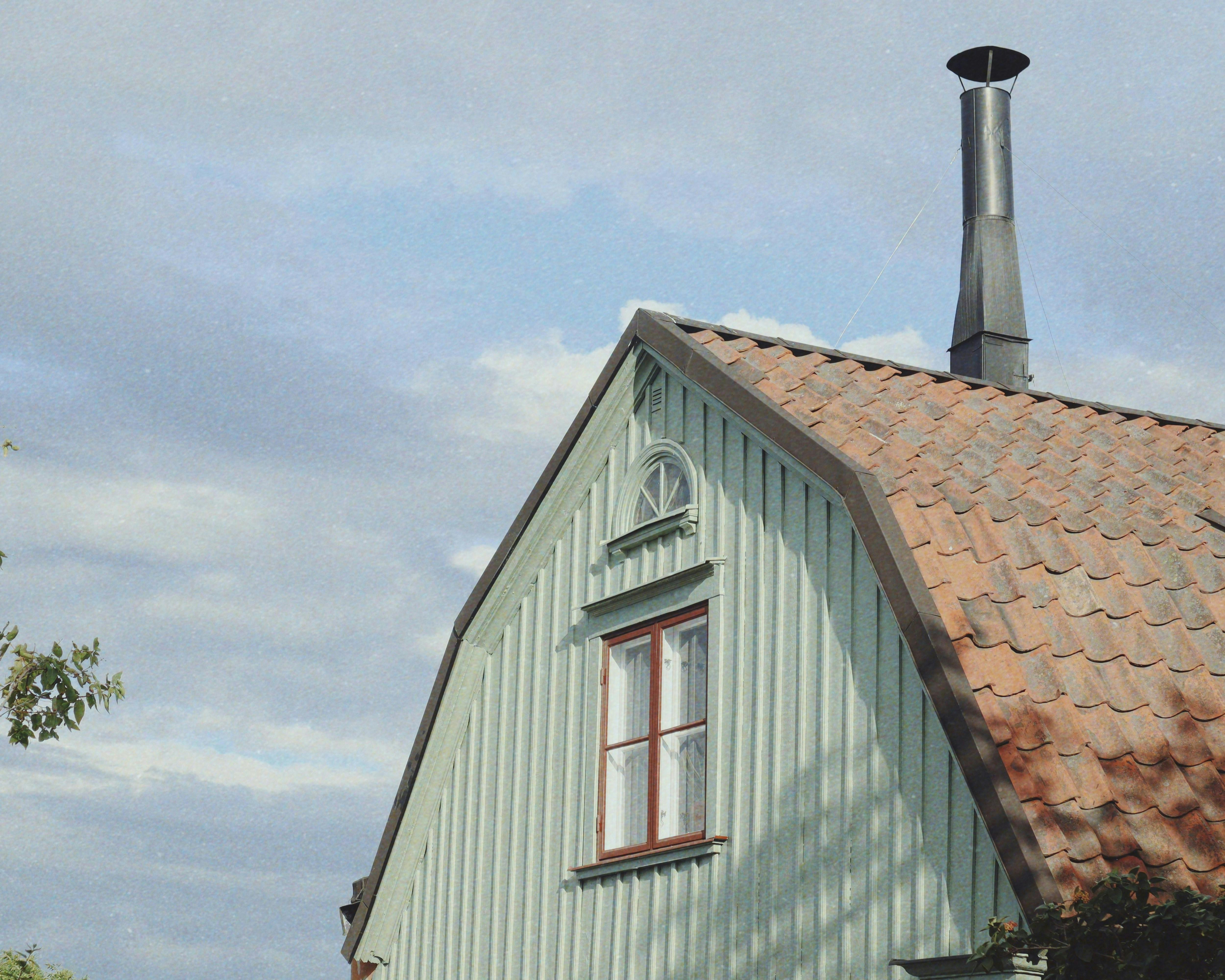Overetagen af et gammelt, grønt træhus.