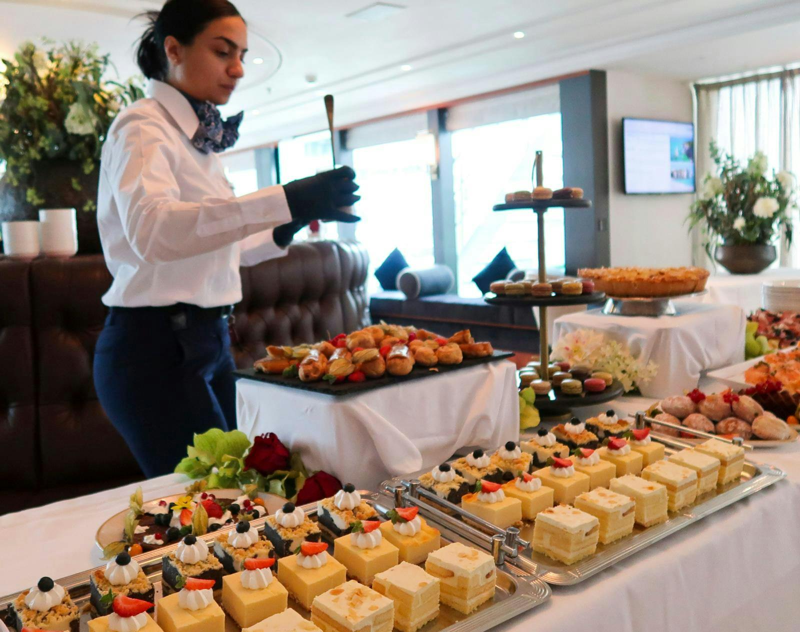 En tjener, der anretter mad ved en buffet.