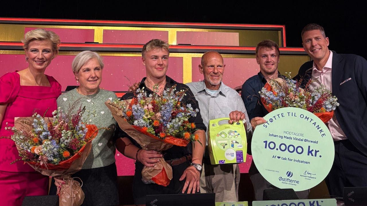 Familie og værter står med præmie og blomster
