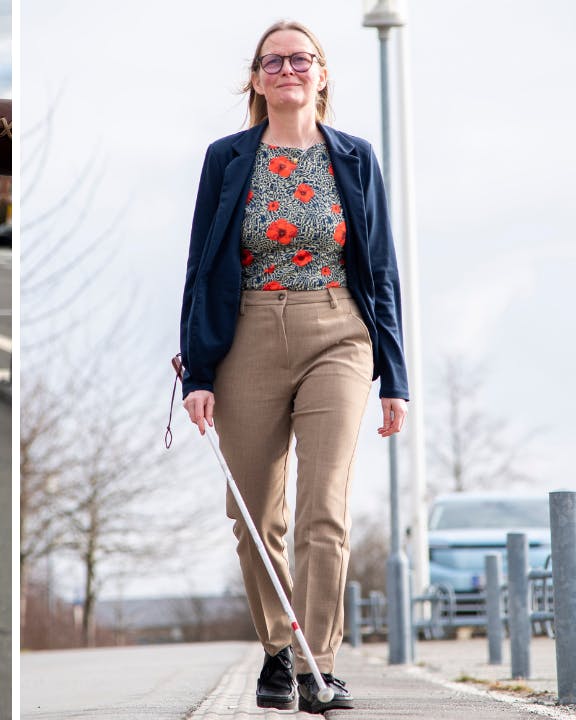 Diana Stentoft med blindestok på ledelinje og cykel med blåt mærkat på styret