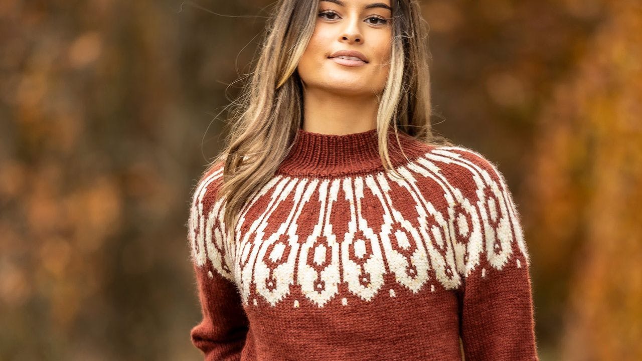 Kvinde med brun strikket sweater i efterårslandskab