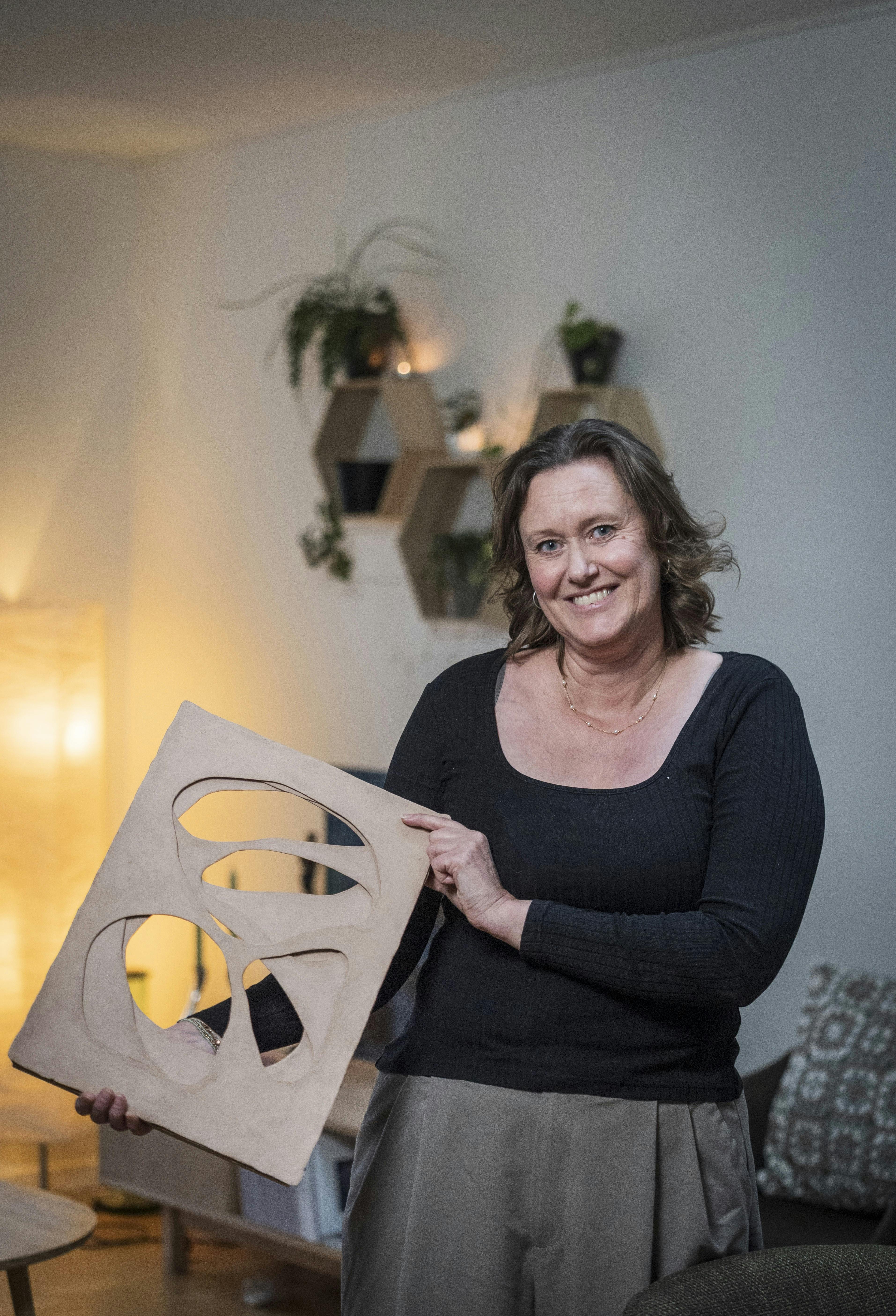 Anja Brix Winkler viser den pris, Foreningen ”Forældre – Fælles om ungelivet i Odder” modtog i 2024 Odder Kommunes Frivillighedspris, som pynter i formandens hjem.