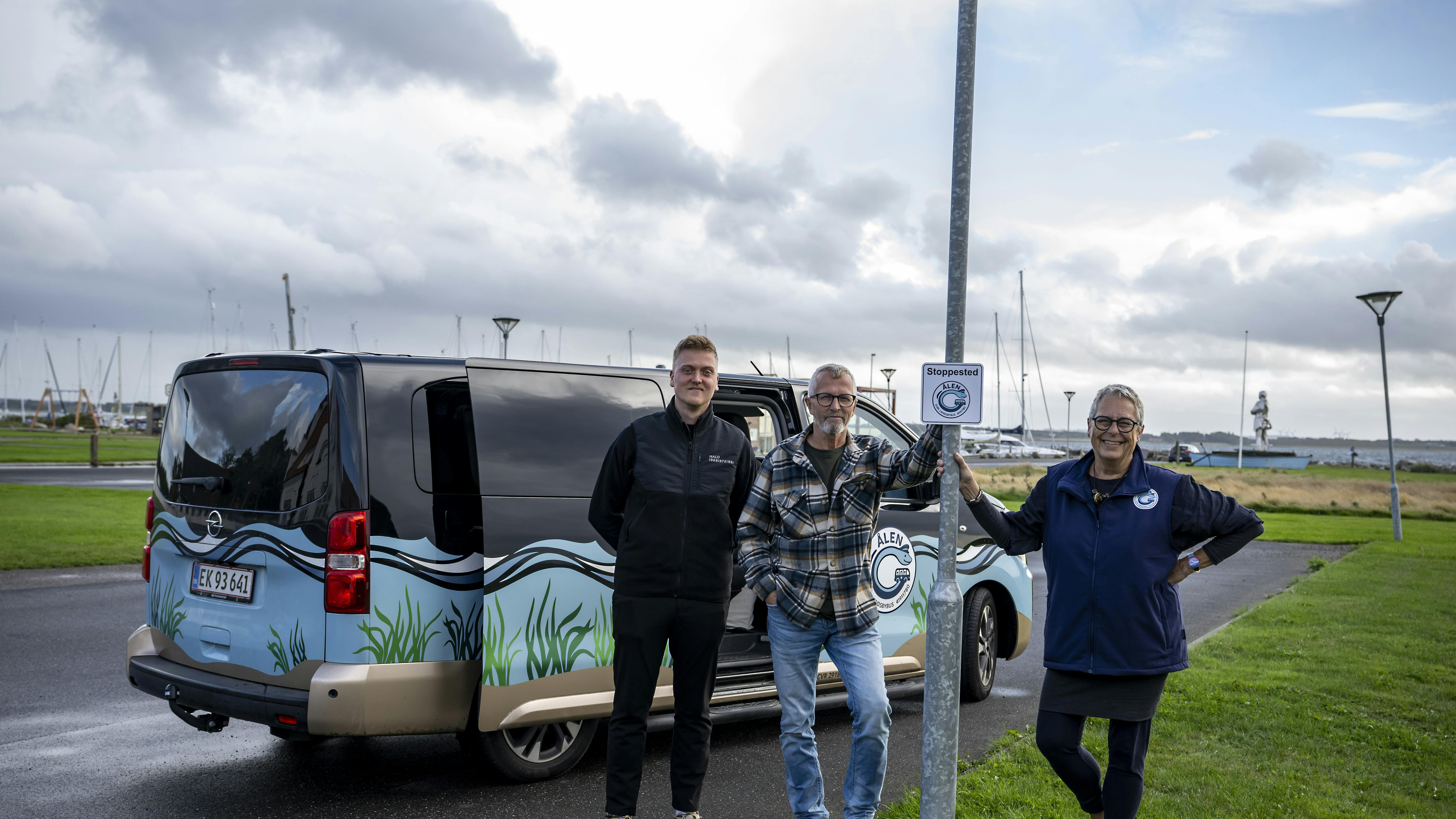 Lisbet Emmery ved ”Ålens” stoppested på havnen sammen med to andre frivillige chauffører Jacob Mikkelsen (t.v.) og Søren Petersen (t.h.).