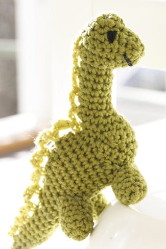 Glæd de mindste med en sjov og blød, hæklet dinosaur, hæklet i bomuld.