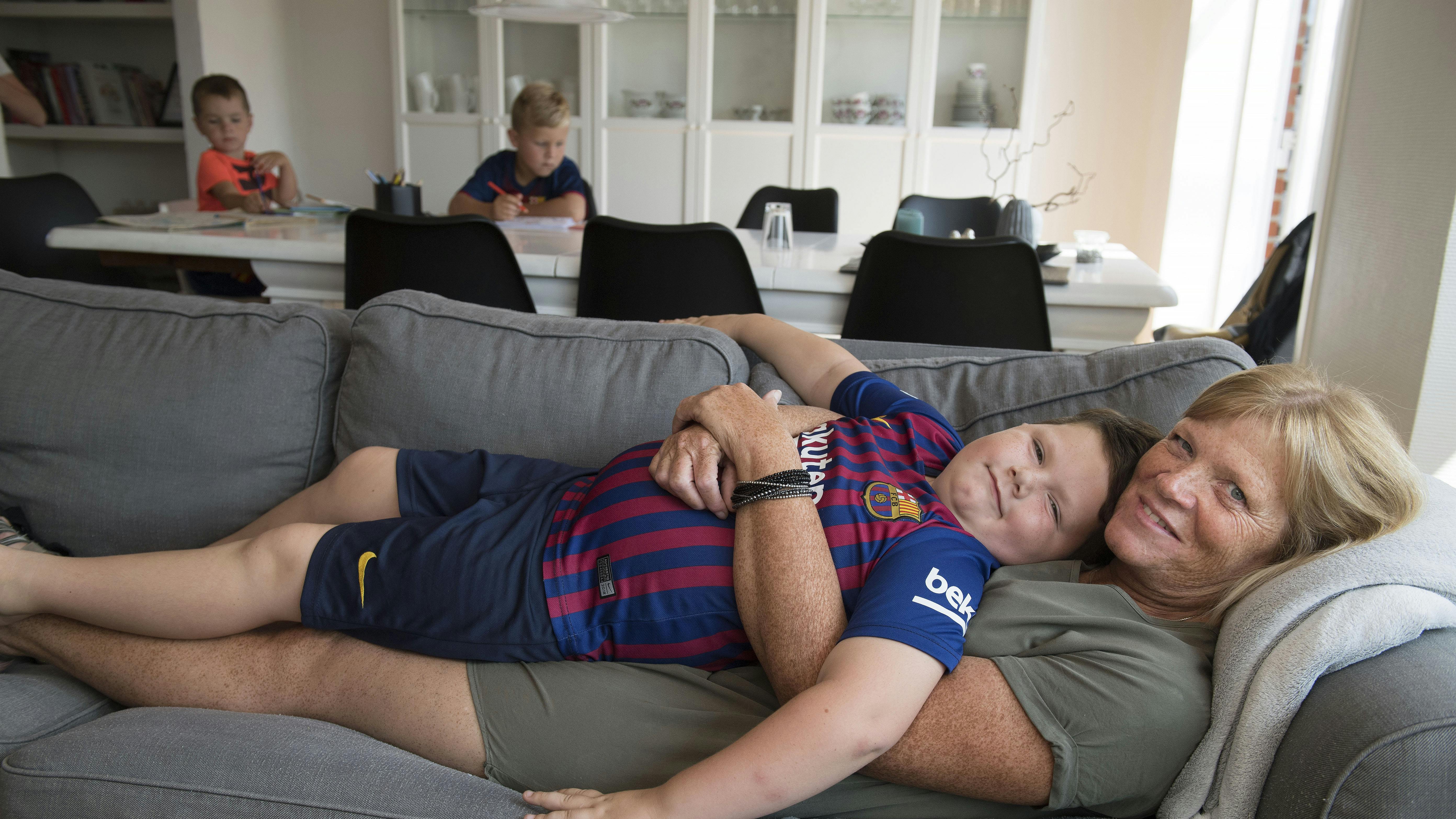 Dame ligger på sofaen