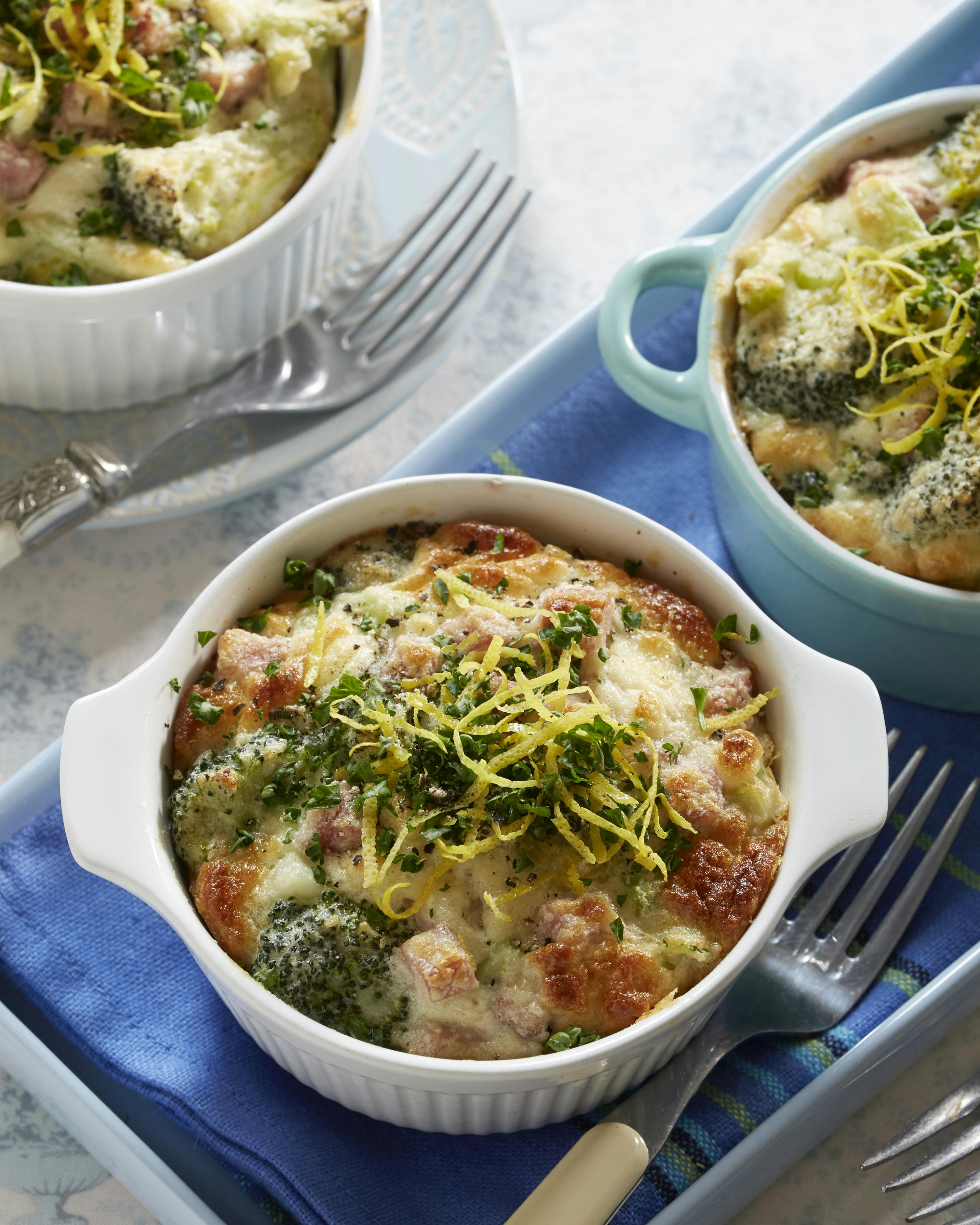 Gratin i portionsstørrelse med broccoli, skinke og hvidløg og toppet med revet citronskal og hakket persille