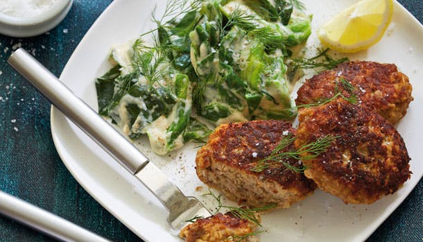 Stuvet spidskål, frikadeller og citron på tallerken 